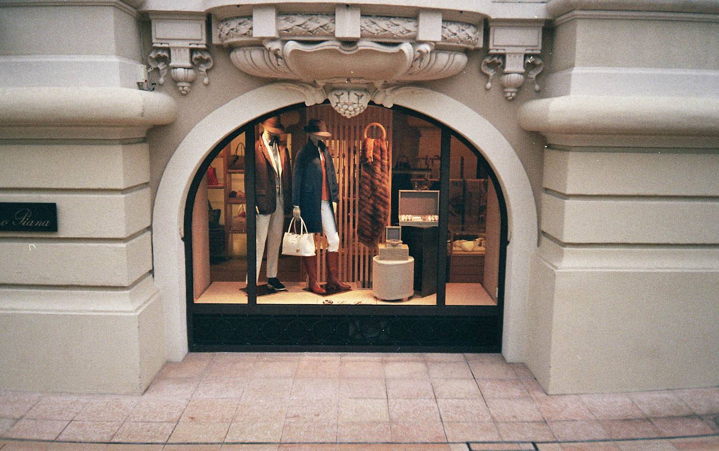 The window of the Loro Piana boutique in Monaco, with mannequins dressed in the house's clothing.