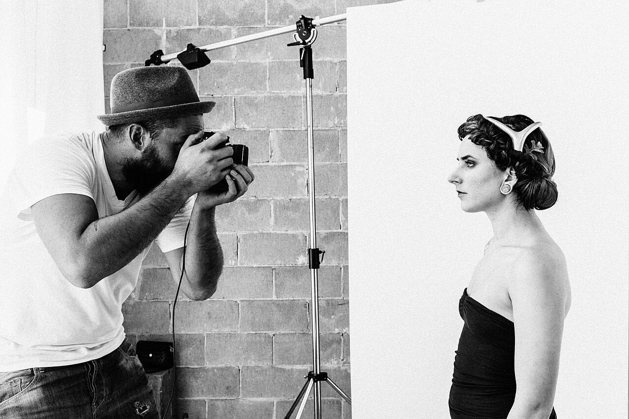 A photographer shooting a model in a studio.